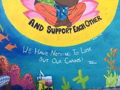 14B Mural with words And support each other, we have nothing to lose but our chains Assata Shakur Paint Jamaica Barry St street art in Kingston Jamaica